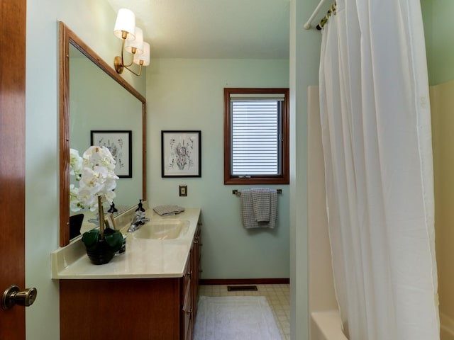 608 Cheshire Dr, Bloomington, IL 61704 - bathroom featuring vanity, tile patterned floors, baseboards, and shower / bath combo