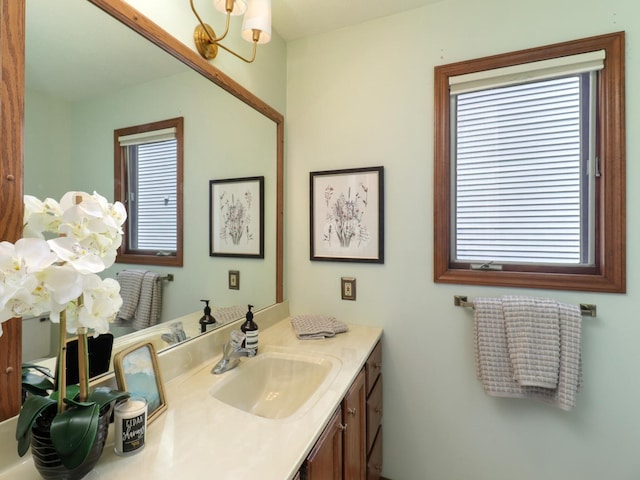 608 Cheshire Dr, Bloomington, IL 61704 - bathroom with vanity and a chandelier