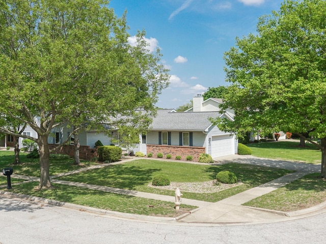 608 Cheshire Dr, Bloomington, IL 61704 - view of front of property featuring a garage, driveway, a chimney, and a front lawn