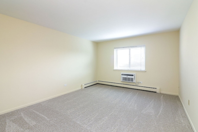 empty room featuring a wall mounted air conditioner, carpet flooring, a baseboard radiator, and baseboards