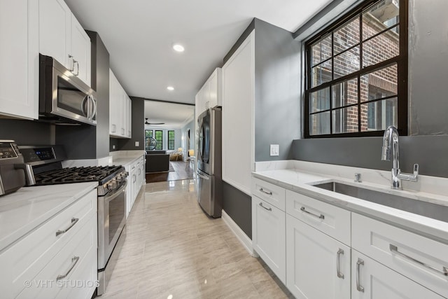 6901 S Oglesby Ave Unit 3A, Chicago, IL 60649 - kitchen featuring light stone counters, ceiling fan, stainless steel appliances, and a sink
