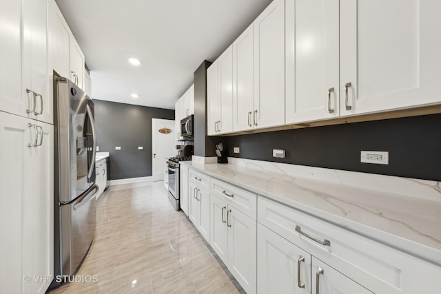 6901 S Oglesby Ave Unit 3A, Chicago, IL 60649 - kitchen featuring light stone countertops, baseboards, appliances with stainless steel finishes, and white cabinetry