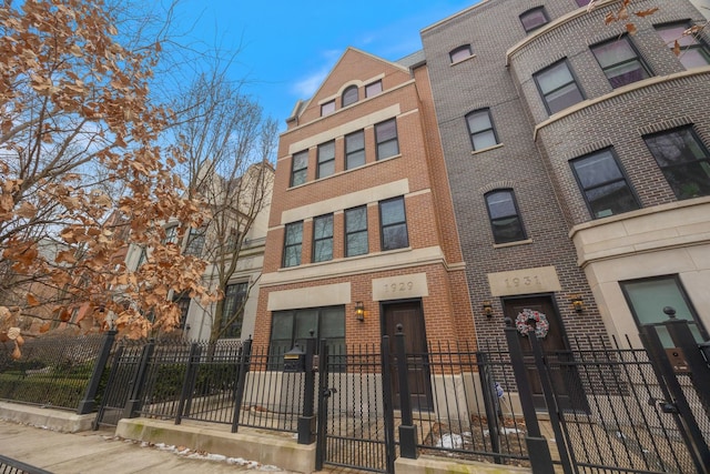 view of front of house featuring a fenced front yard and brick siding