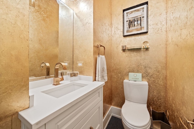 bathroom featuring vanity and toilet