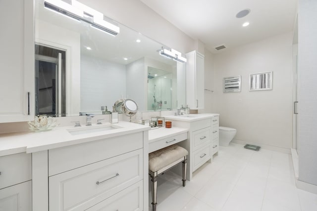 bathroom with visible vents, baseboards, toilet, a shower stall, and vanity