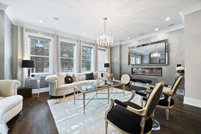 living room featuring an inviting chandelier, ornamental molding, and wood finished floors