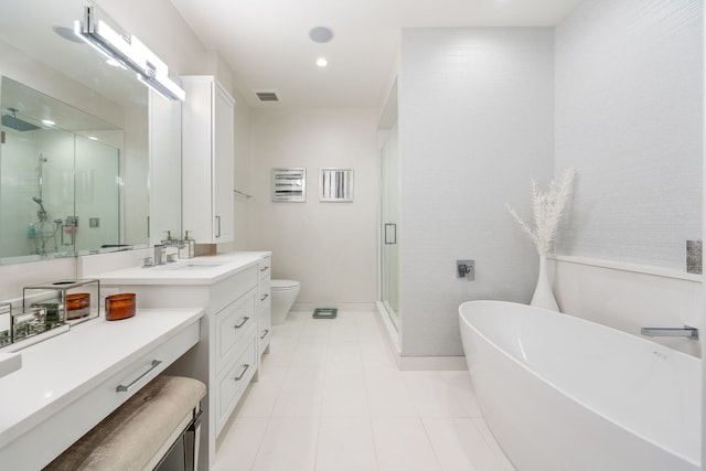 bathroom with a freestanding tub, vanity, visible vents, toilet, and a stall shower