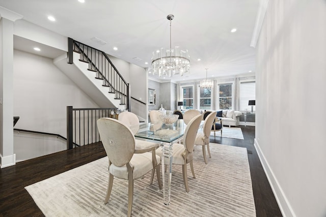 dining space featuring recessed lighting, baseboards, an inviting chandelier, and wood finished floors