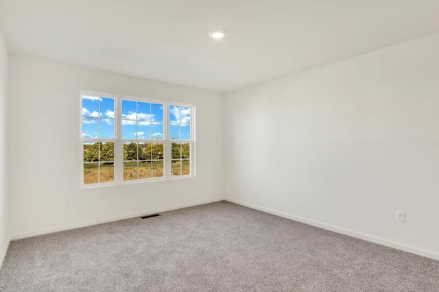 carpeted empty room with baseboards and recessed lighting