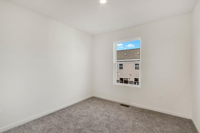 unfurnished room featuring visible vents, baseboards, and carpet