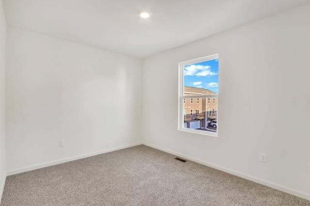empty room featuring recessed lighting, visible vents, baseboards, and carpet floors