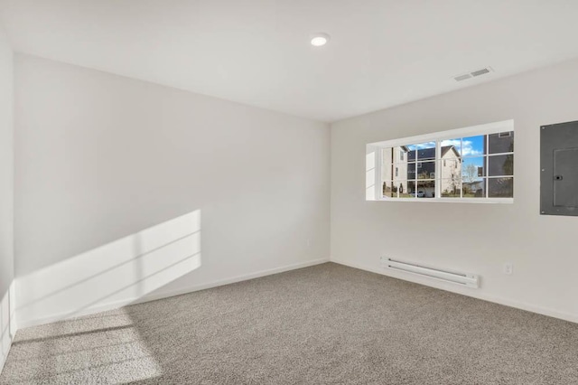 spare room with a baseboard heating unit, baseboards, electric panel, visible vents, and carpet