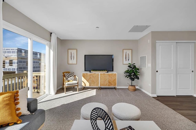 living area featuring carpet floors, baseboards, and visible vents