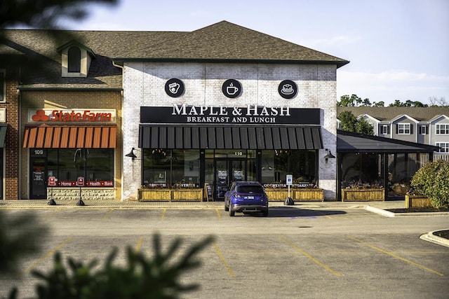 view of building exterior with uncovered parking