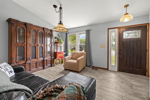 208 Sprucewood Ct, Round Lake Beach, IL 60073 - entrance foyer featuring light wood-style flooring, lofted ceiling, and baseboards