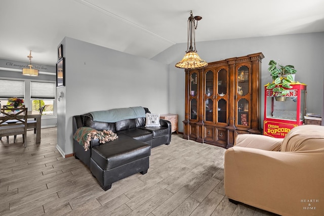 208 Sprucewood Ct, Round Lake Beach, IL 60073 - living area with light wood-style floors, vaulted ceiling, and baseboards
