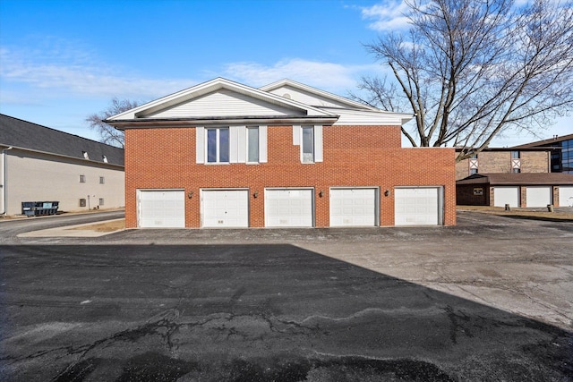 5721 Circle Dr Unit 304, Oak Lawn, IL 60453 - exterior space featuring an attached garage, aphalt driveway, and brick siding