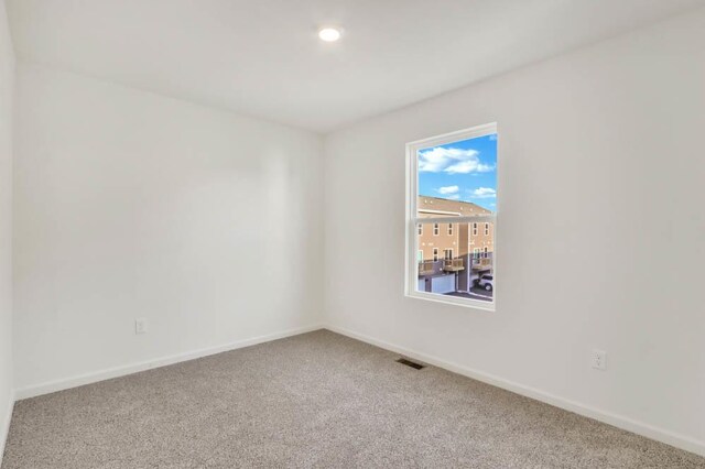 unfurnished room featuring recessed lighting, baseboards, visible vents, and carpet floors
