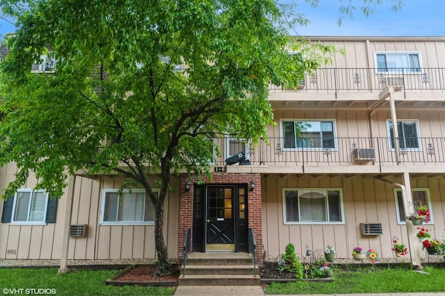 2508 Algonquin Rd Unit 3, Rolling Meadows, IL 60008 - view of front of house with a balcony, board and batten siding, brick siding, and a wall mounted AC