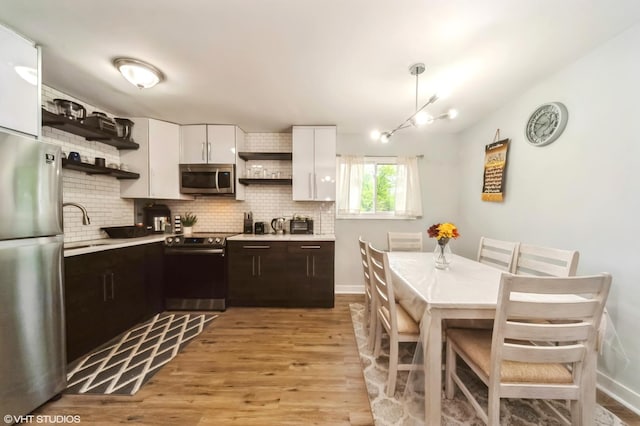 2508 Algonquin Rd Unit 3, Rolling Meadows, IL 60008 - kitchen with open shelves, stainless steel appliances, a sink, tasteful backsplash, and light countertops
