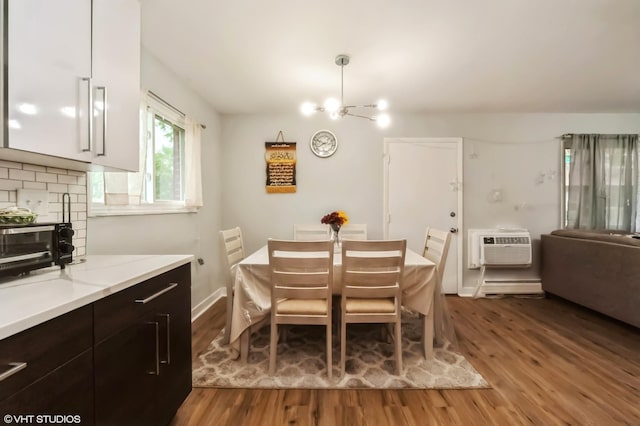 2508 Algonquin Rd Unit 3, Rolling Meadows, IL 60008 - dining area with a chandelier, wood finished floors, and a wall mounted air conditioner