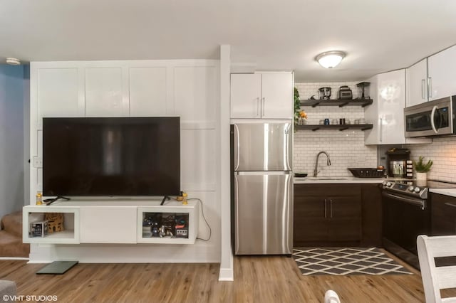 2508 Algonquin Rd Unit 3, Rolling Meadows, IL 60008 - kitchen featuring stainless steel appliances, a sink, open shelves, light countertops, and tasteful backsplash