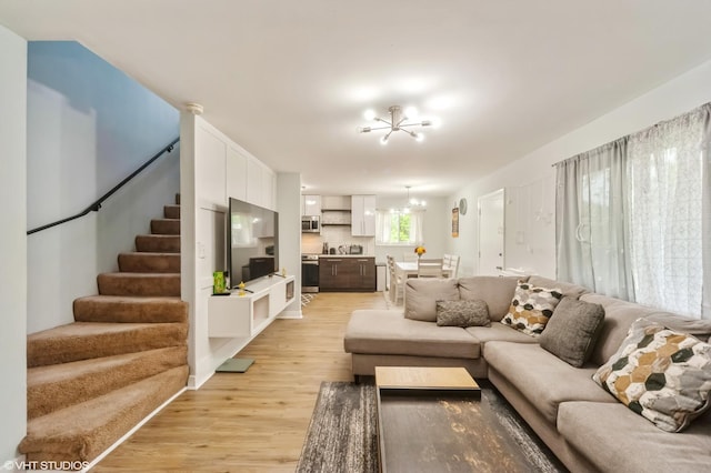 2508 Algonquin Rd Unit 3, Rolling Meadows, IL 60008 - living room with a chandelier, light wood-style floors, and stairway