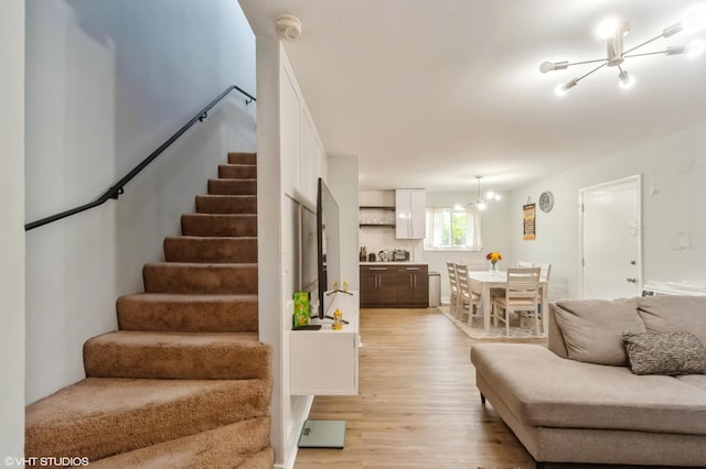 2508 Algonquin Rd Unit 3, Rolling Meadows, IL 60008 - living area with a chandelier, stairs, and light wood-style flooring