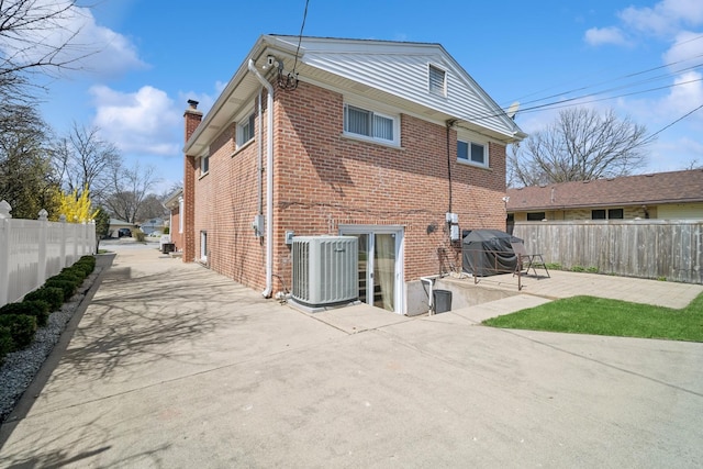 9249 Kildare Ave, Skokie, IL 60077 - rear view of property with a patio area, brick siding, and a chimney