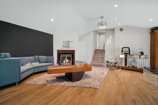 9249 Kildare Ave, Skokie, IL 60077 - living area featuring vaulted ceiling, light wood-style floors, a premium fireplace, stairway, and recessed lighting
