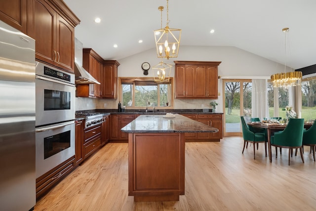 9249 Kildare Ave, Skokie, IL 60077 - kitchen featuring stainless steel appliances, a chandelier, wall chimney exhaust hood, lofted ceiling, and a kitchen island