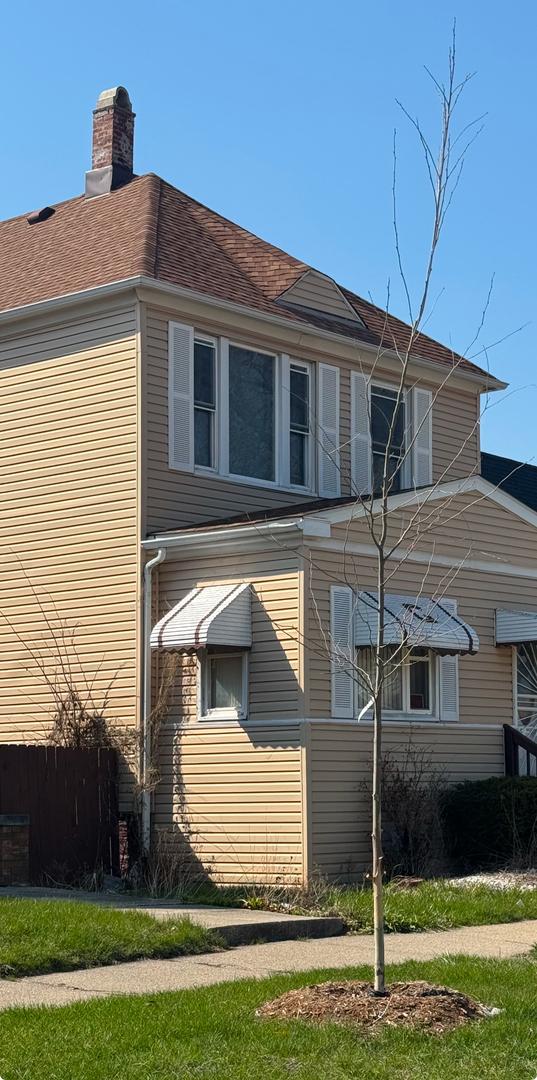 view of side of home with a chimney