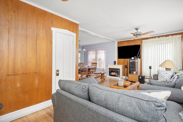 2142 N Mobile Ave, Chicago, IL 60639 - living area with wood finished floors, ceiling fan, a lit fireplace, and baseboards