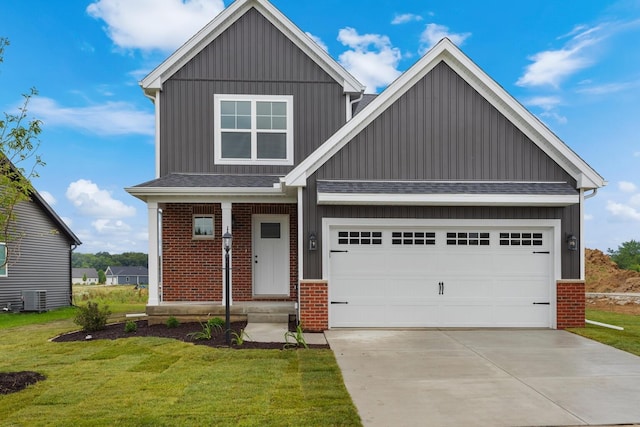 craftsman-style home with brick siding, a front lawn, board and batten siding, and driveway