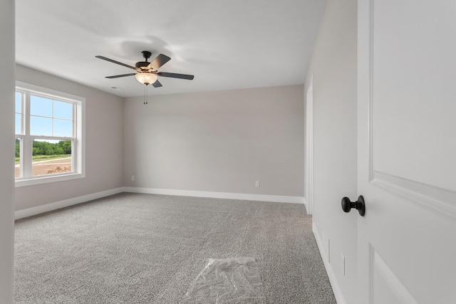 empty room with carpet floors, ceiling fan, and baseboards