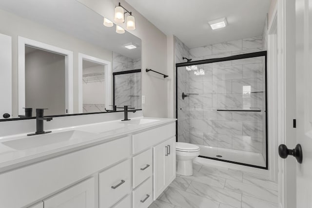 bathroom with a sink, marble finish floor, and a stall shower