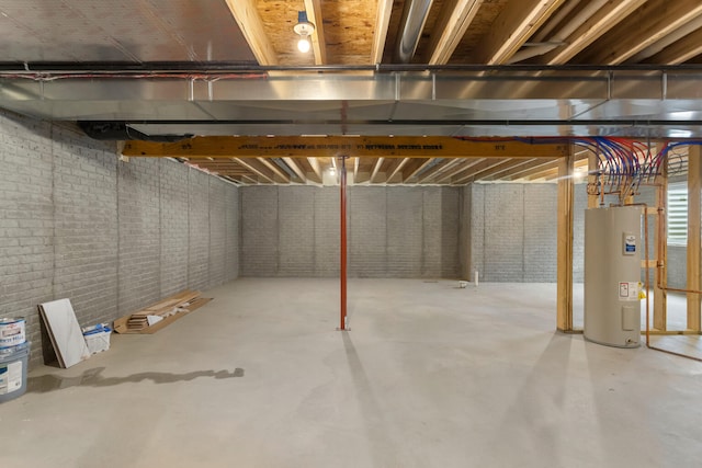 unfinished basement with brick wall and electric water heater