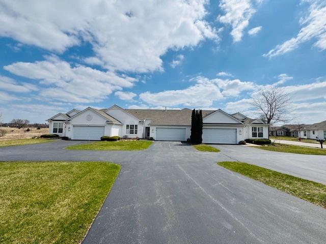 11246 Bellflower Ln, Huntley, IL 60142 - ranch-style home with a residential view, driveway, an attached garage, and a front lawn