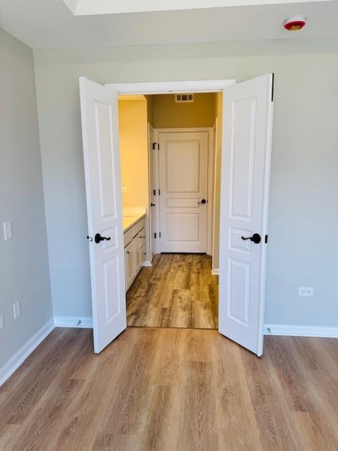 11246 Bellflower Ln, Huntley, IL 60142 - corridor with light wood-style flooring, baseboards, and visible vents
