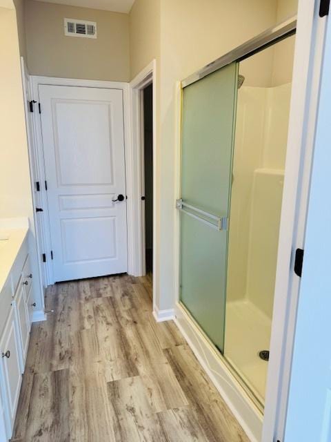 11246 Bellflower Ln, Huntley, IL 60142 - full bath featuring visible vents, a shower stall, vanity, and wood finished floors
