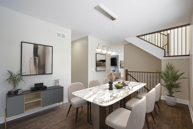 dining room featuring visible vents, dark wood-style flooring, and baseboards