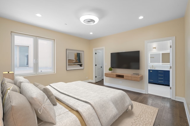 bedroom featuring dark wood-type flooring, baseboards, recessed lighting, and ensuite bath