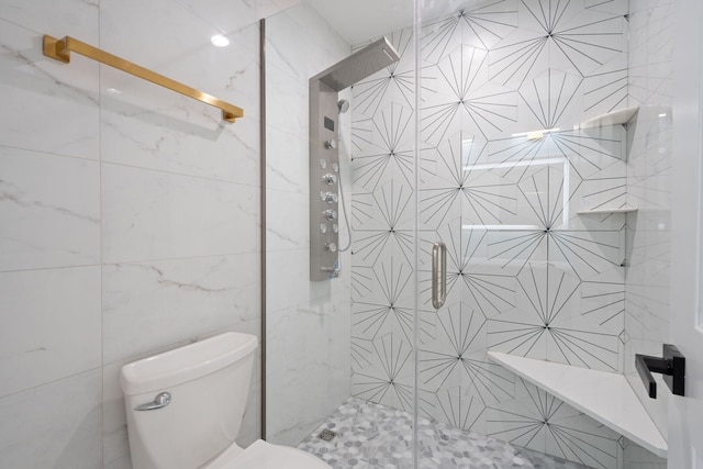 bathroom with toilet, a stall shower, and tile walls
