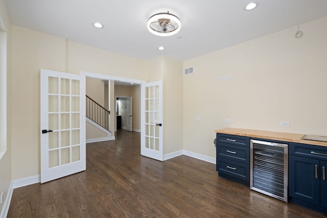 bar featuring french doors, baseboards, beverage cooler, and dark wood-style floors