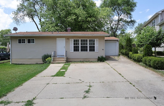 1032 Brentwood Dr, Round Lake Beach, IL 60073 - view of front facade with a garage, a front lawn, a chimney, and concrete driveway