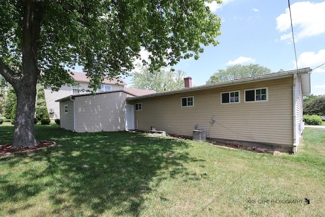 1032 Brentwood Dr, Round Lake Beach, IL 60073 - rear view of property with a lawn and a chimney