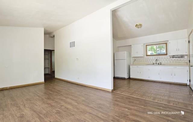1032 Brentwood Dr, Round Lake Beach, IL 60073 - kitchen featuring freestanding refrigerator, light countertops, tasteful backsplash, vaulted ceiling, and wood finished floors
