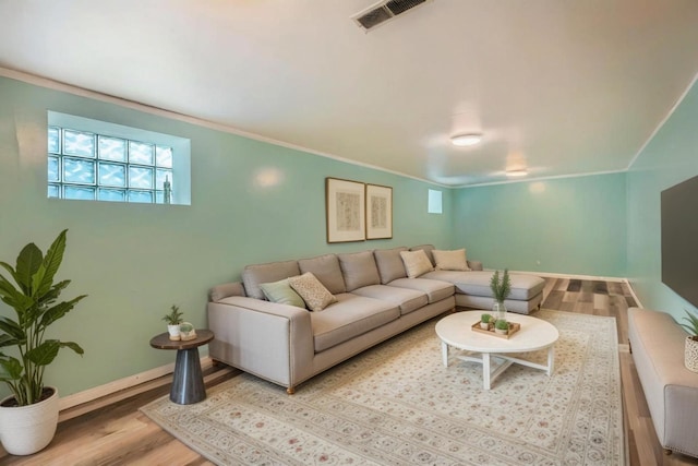 8151 S Bennett Ave, Chicago, IL 60617 - living room featuring visible vents, ornamental molding, baseboards, and wood finished floors