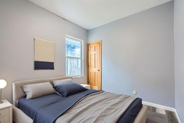 8151 S Bennett Ave, Chicago, IL 60617 - bedroom with baseboards and wood finished floors