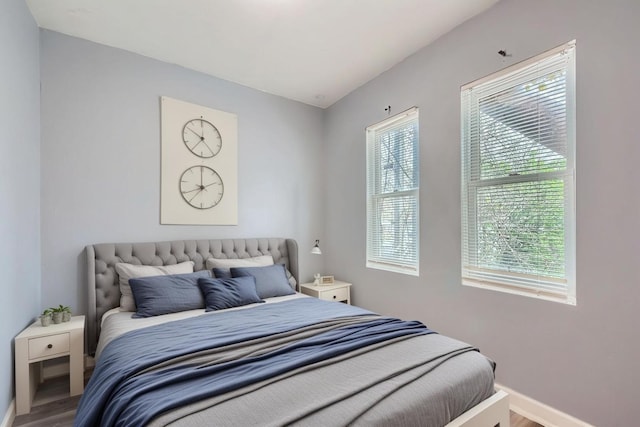 8151 S Bennett Ave, Chicago, IL 60617 - bedroom featuring baseboards, wood finished floors, and multiple windows